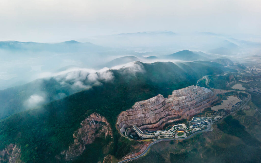 The 375,000-­ square-foot hotel, its architecture by China Architecture Design & Research Group, sits within the quarry that cuts into the side of Tangshan Mountain.