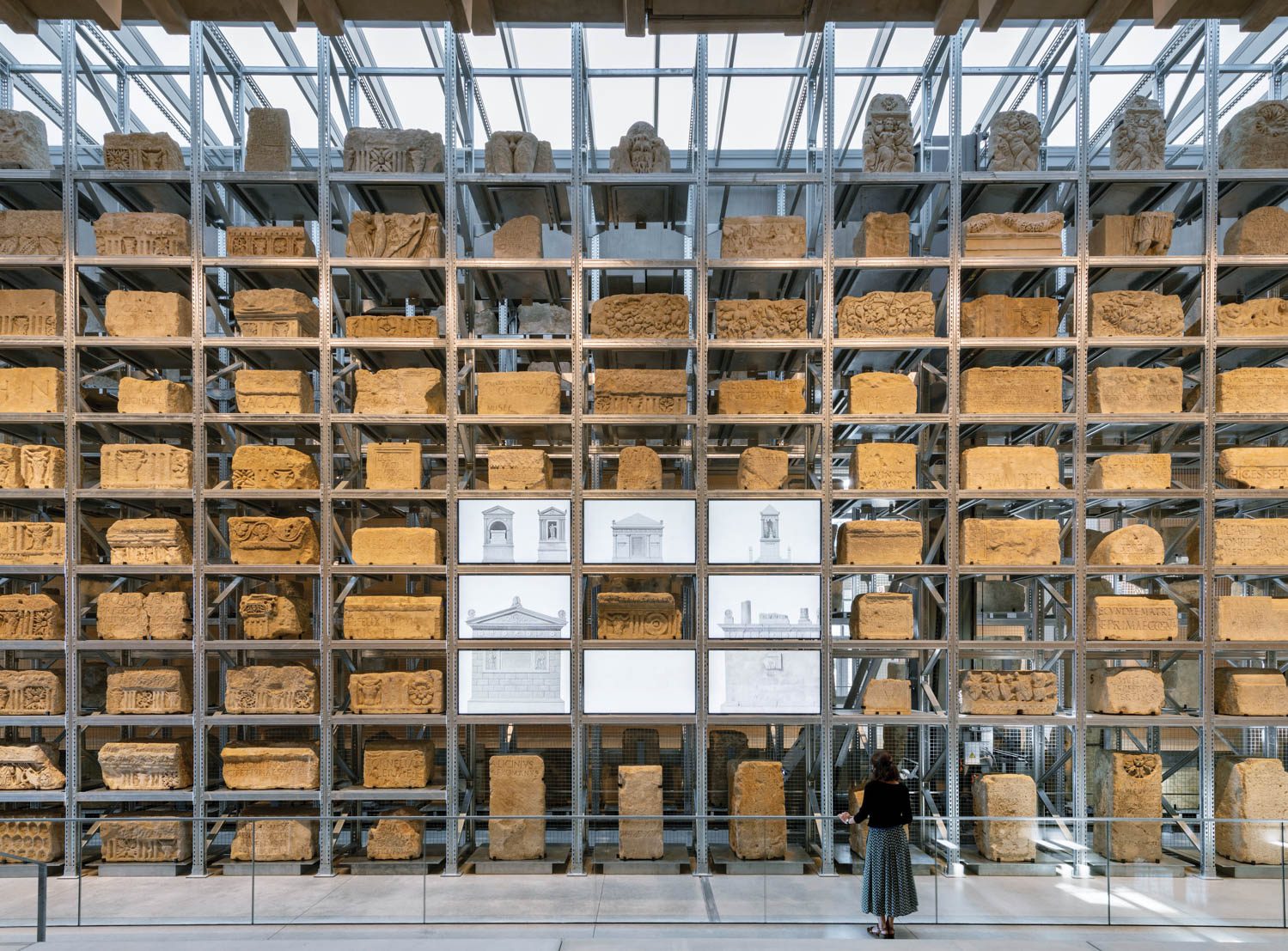 More than 800 Roman funerary stones are displayed in a custom industrial shelving system at the Narbo Via Museum in Narbonne, France, by Foster + Partners.