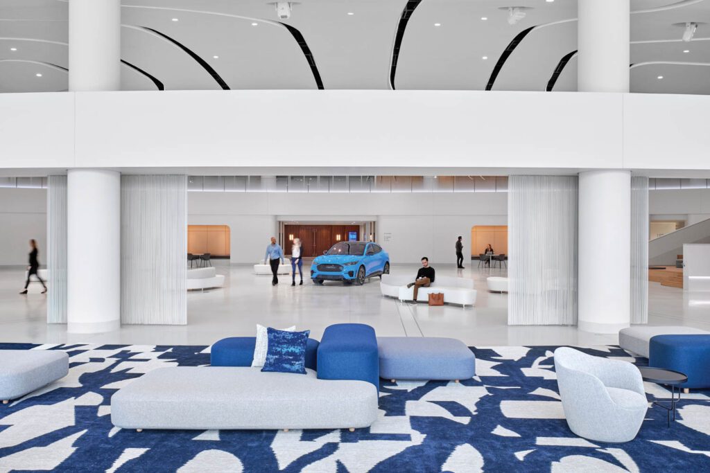 a custom rug patterned with deconstructed ovals derived from Ford’s logo in the welcome lounge