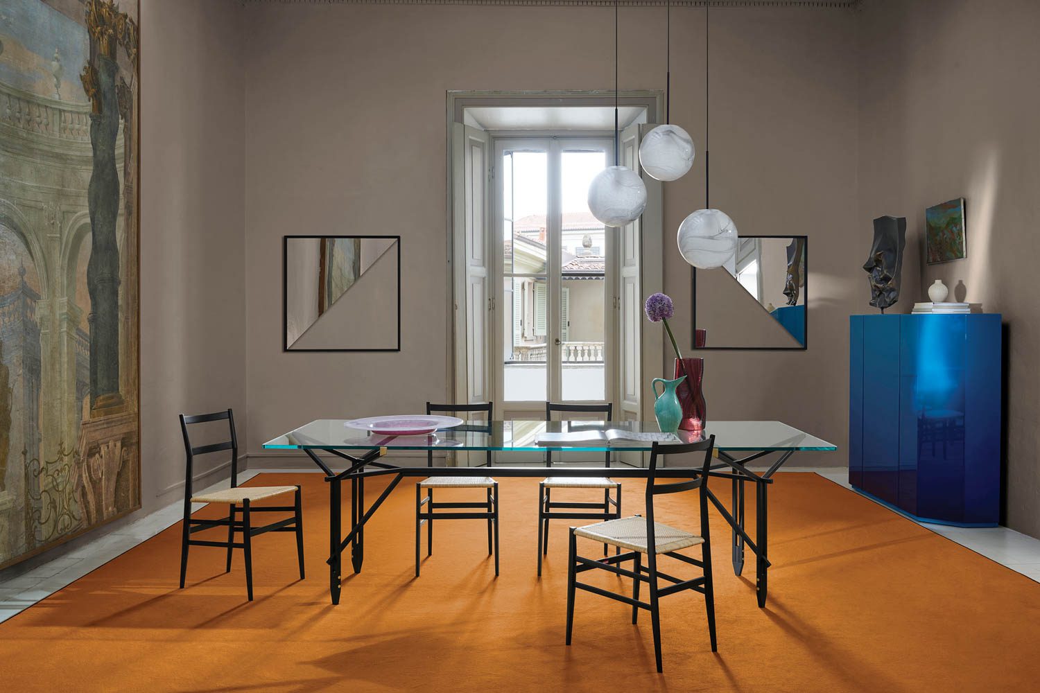 Superleggera chairs around a glass dining table
