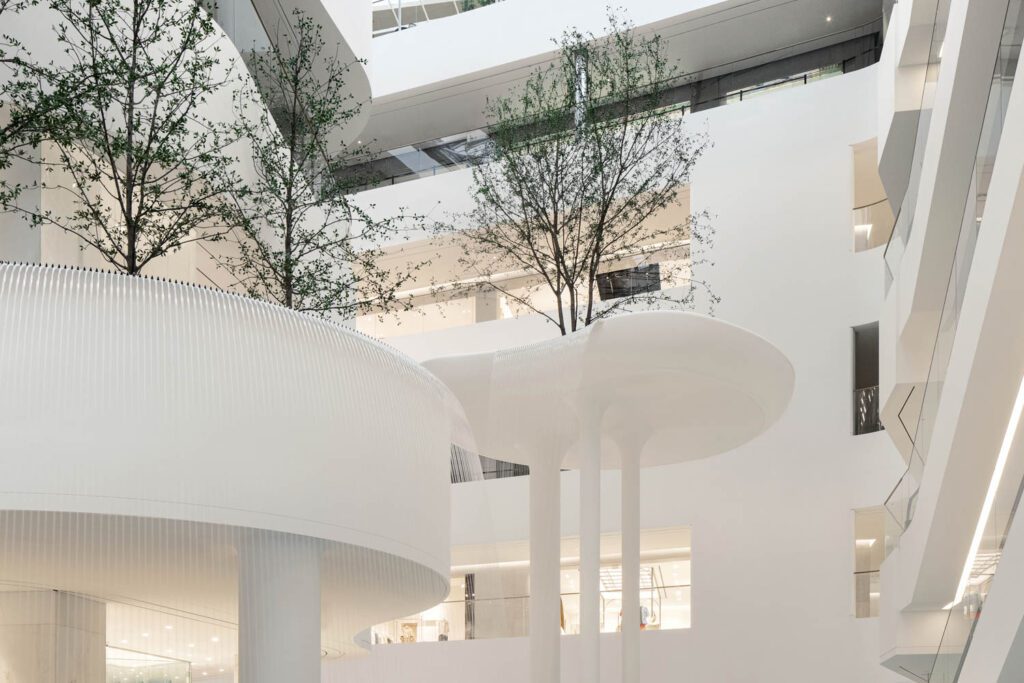In the atrium, guests are greeted by a sculptural waterfall garden that plays with scale.