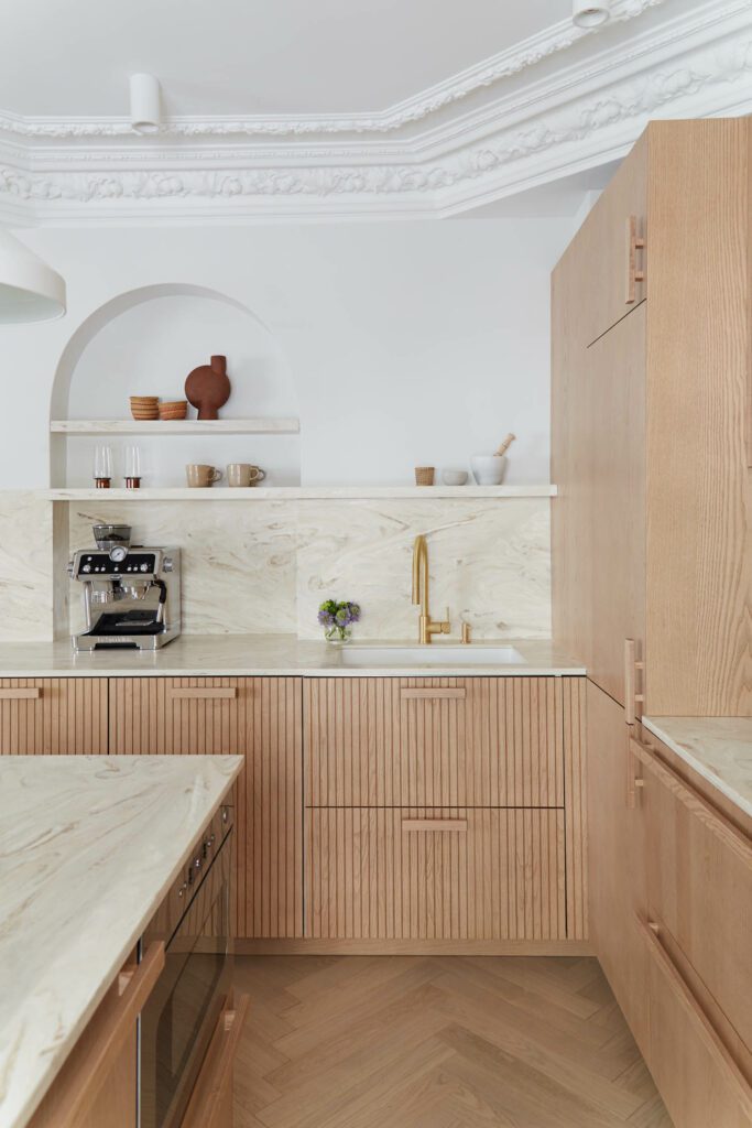 a kitchen with a recessed arch shelf