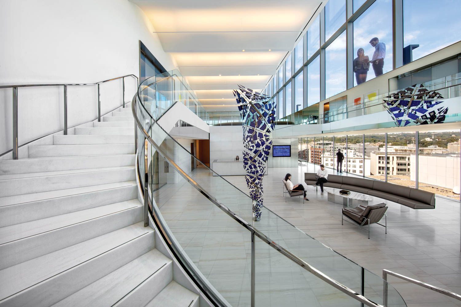 A Lasa staircase with balustrades of polished stainless steel and glass connects reception and the conference area, while the private Paul Hastings roof terrace overlooks the sculpture.
