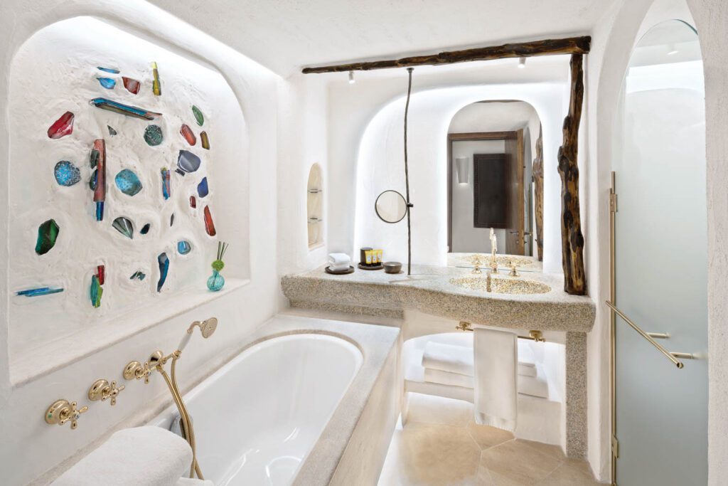 stained glass is in the wall above the bath tub