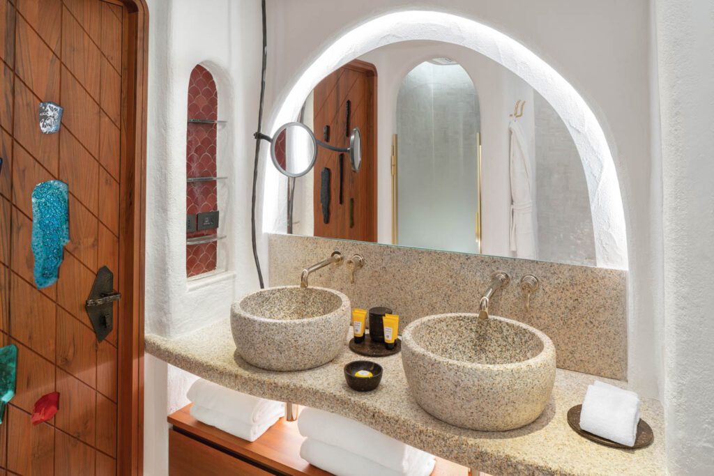 a guest bathroom with granite sinks and vanity