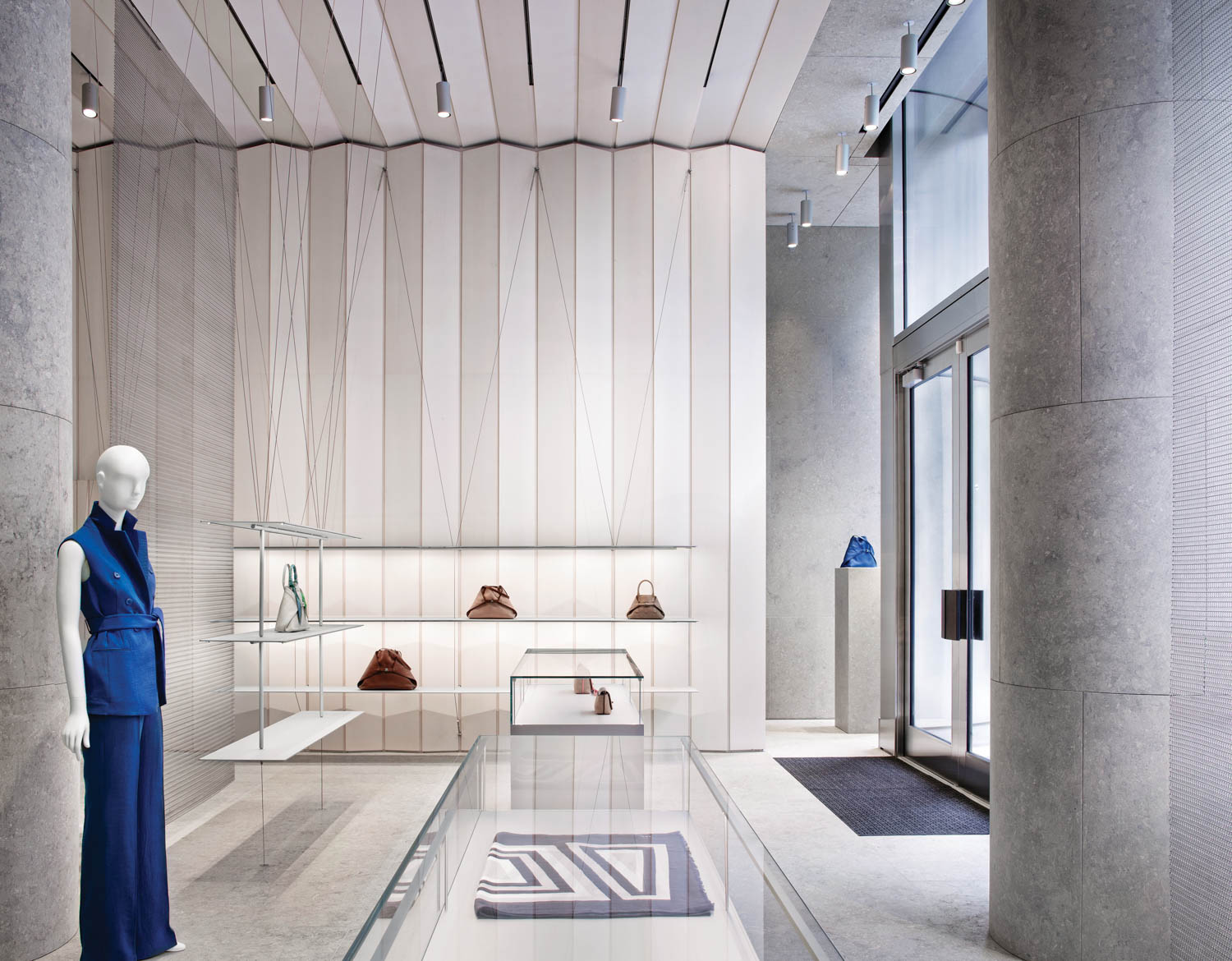 a manequin in a blue matching set in the Akris store in Washington by David Chipperfield Architects