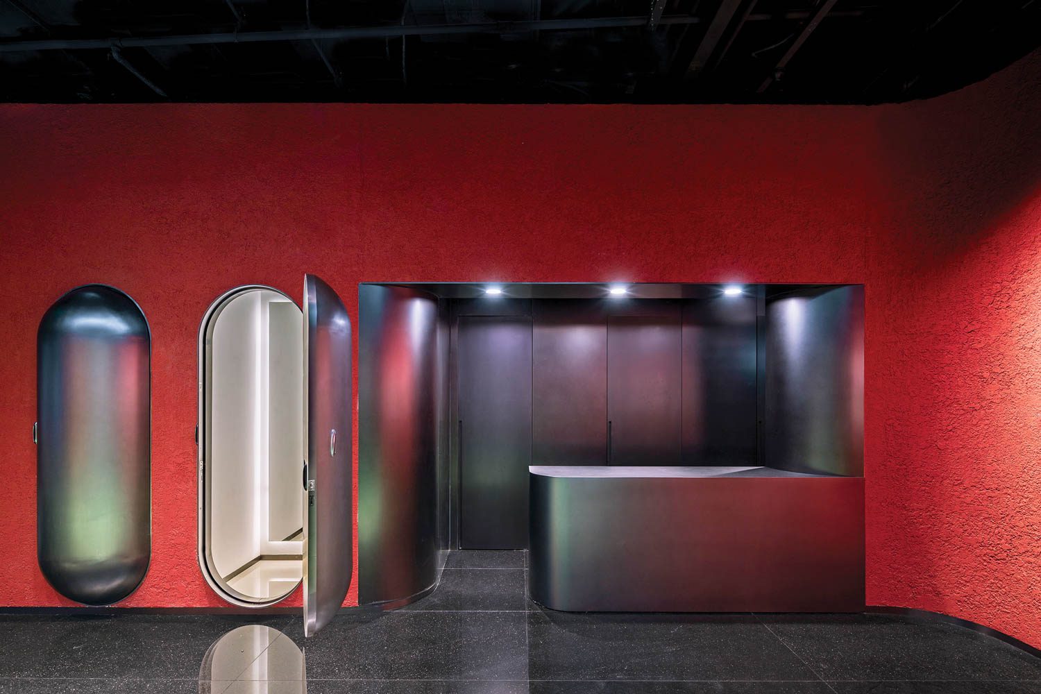 a red wall with curved doors in KIKS Beijing by ROOI Design & Research