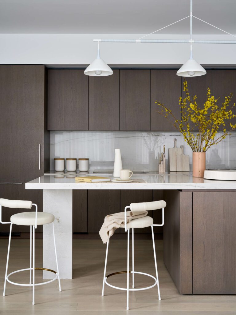 The kitchen includes Iva stools by Grazia + Co, a Stem Shade Rig light fixture by Pelle, vases from Rivet by Jenni Kayne and cutting boards by Black Creek Merchantile.