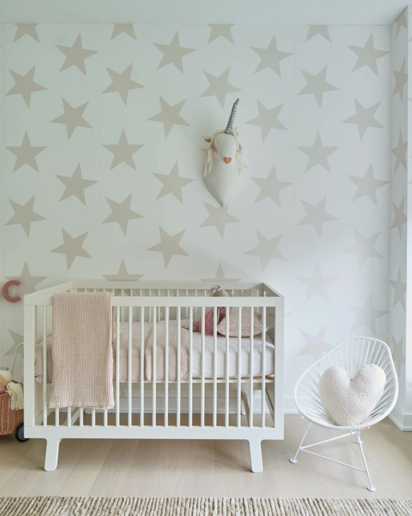 The nursery was crafted with Marley and Malek Kids wallpaper, Oeuf crib, and an Armadillo rug. 