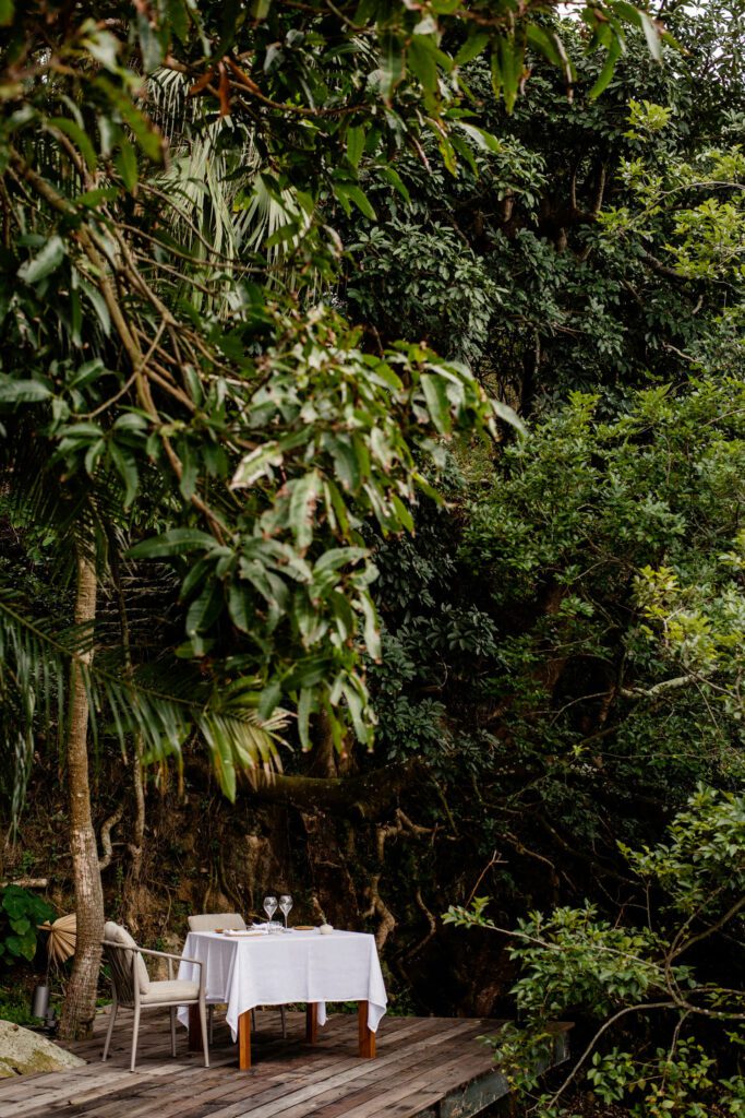 A romantic table set up in the jungle offers a chance to dine under the stars at Ooak Lamma