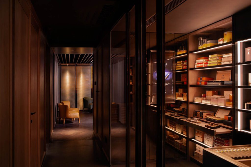 View at Club C+ towards salons with cigar tasting room and humidor storage to right