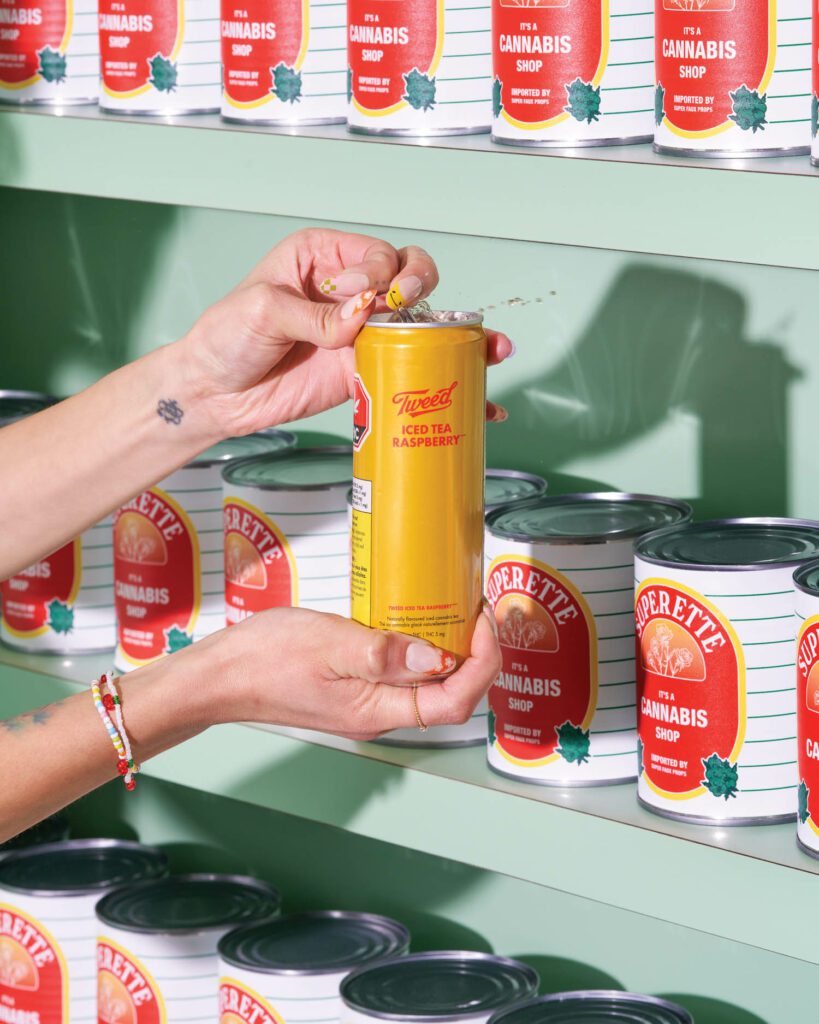 Matte-enameled Formica shelving is stocked with custom prop tomato cans wrapped in Superette labels.