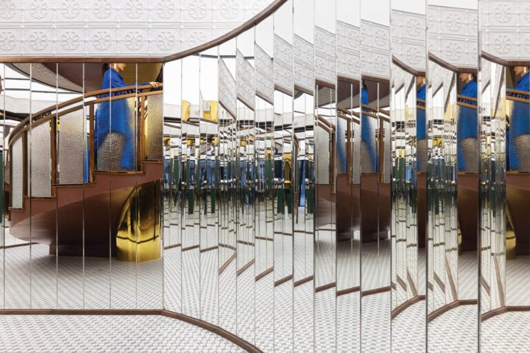 At Haydon Shanghai, a cosmetics store designed by Various Associates, a partition of arcing slats in mirrored stainless steel distorts the reflections of the spiral staircase connecting its two levels.