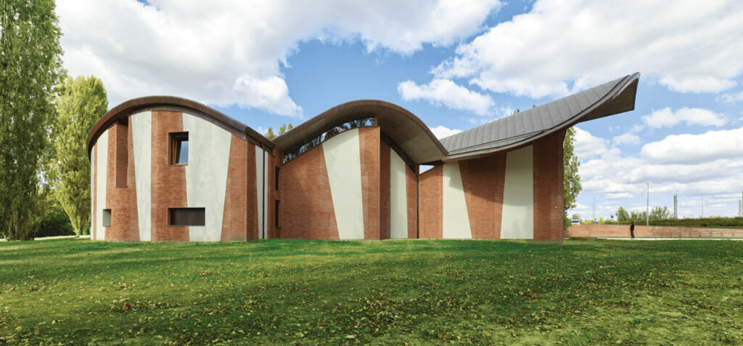 The sawtooth brickwork cladding San Giacomo Apostolo Church, a ground-up Catholic parish complex in Ferrara, Italy, by Benedetta Tagliabue-EMBT, nods to the carved facade of a 15th-century palazzo nearby, for an appearance that’s both modern and historic.