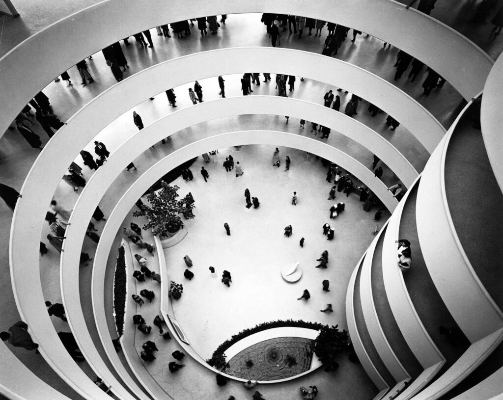 1959 - Paul Rudolf smiles for the camera, while Frank Lloyd Wright's Solomon R. Guggenheim Museum opens in New York.