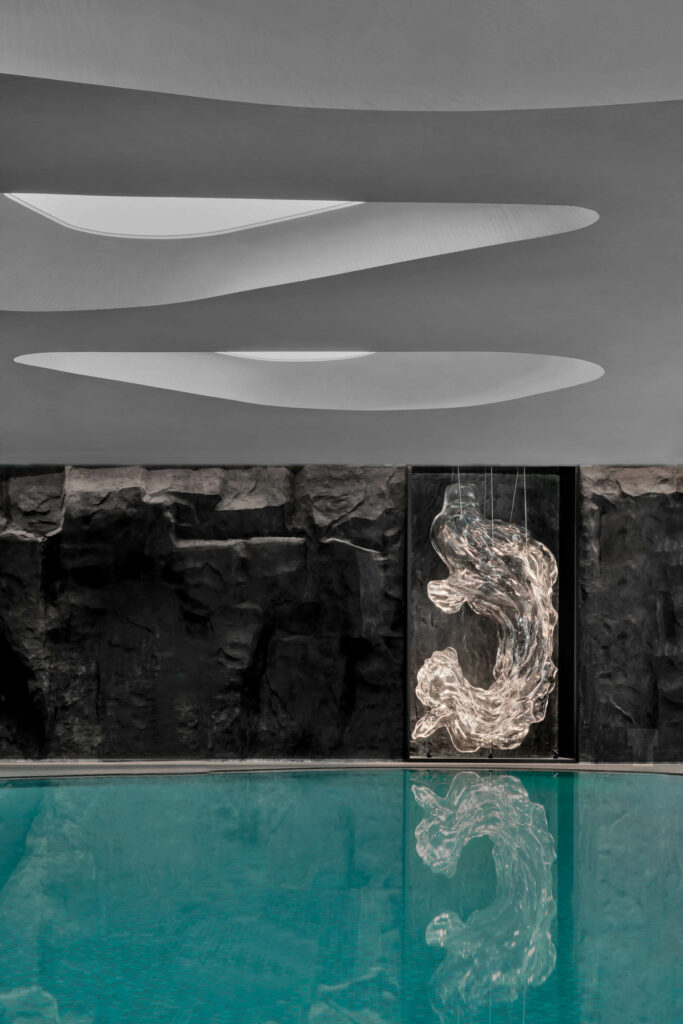 Skylights above the subterranean indoor pool help illuminate a glass sculpture.