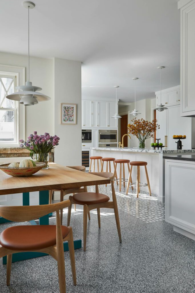 contemporary kitchen with two tile patterns: one a gray-toned terrazzo, the other incorporating large Bianco Dolomiti marble chips. 