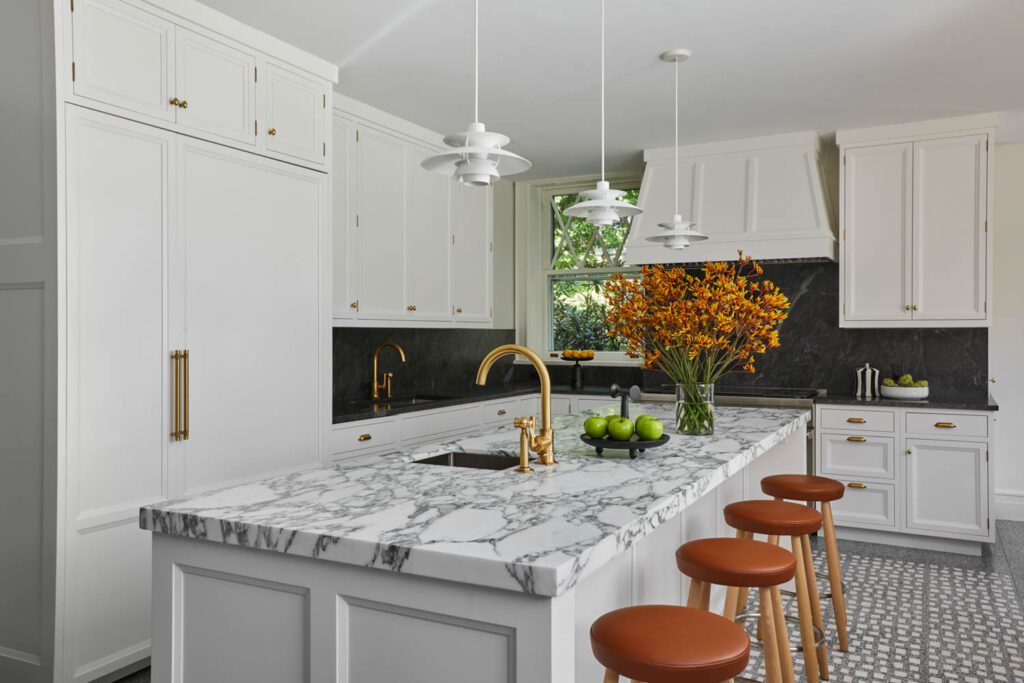 contemporary kitchen with a marble island by Dufner Heighes