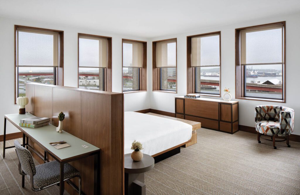 A corner room shows off Breuer’s deep window wells, which have been newly wrapped in stained maple, and, behind the bed, his Cesca task chair covered in an Albers fabric.