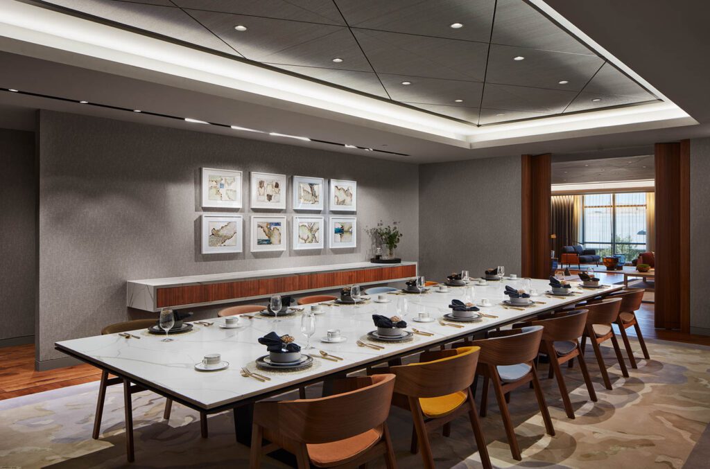 A Halcon table with custom quartz top and custom walnut and quartz consoles define the third floor dining and meeting room for executives, with Grand Rapids Chair Co. seating covered in Maharam mohair.