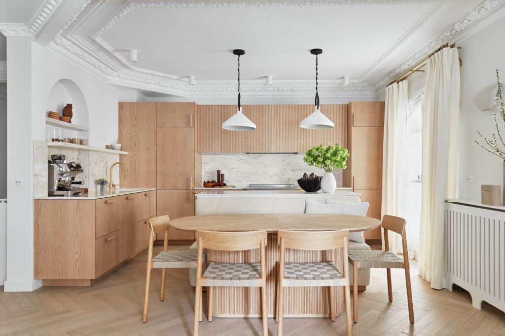 The kitchen's natural aesthetic comes together courtesy of Superfront cabinets, Betty chairs from &Tradition, and Limoges pendant lights by Circa Lighting.