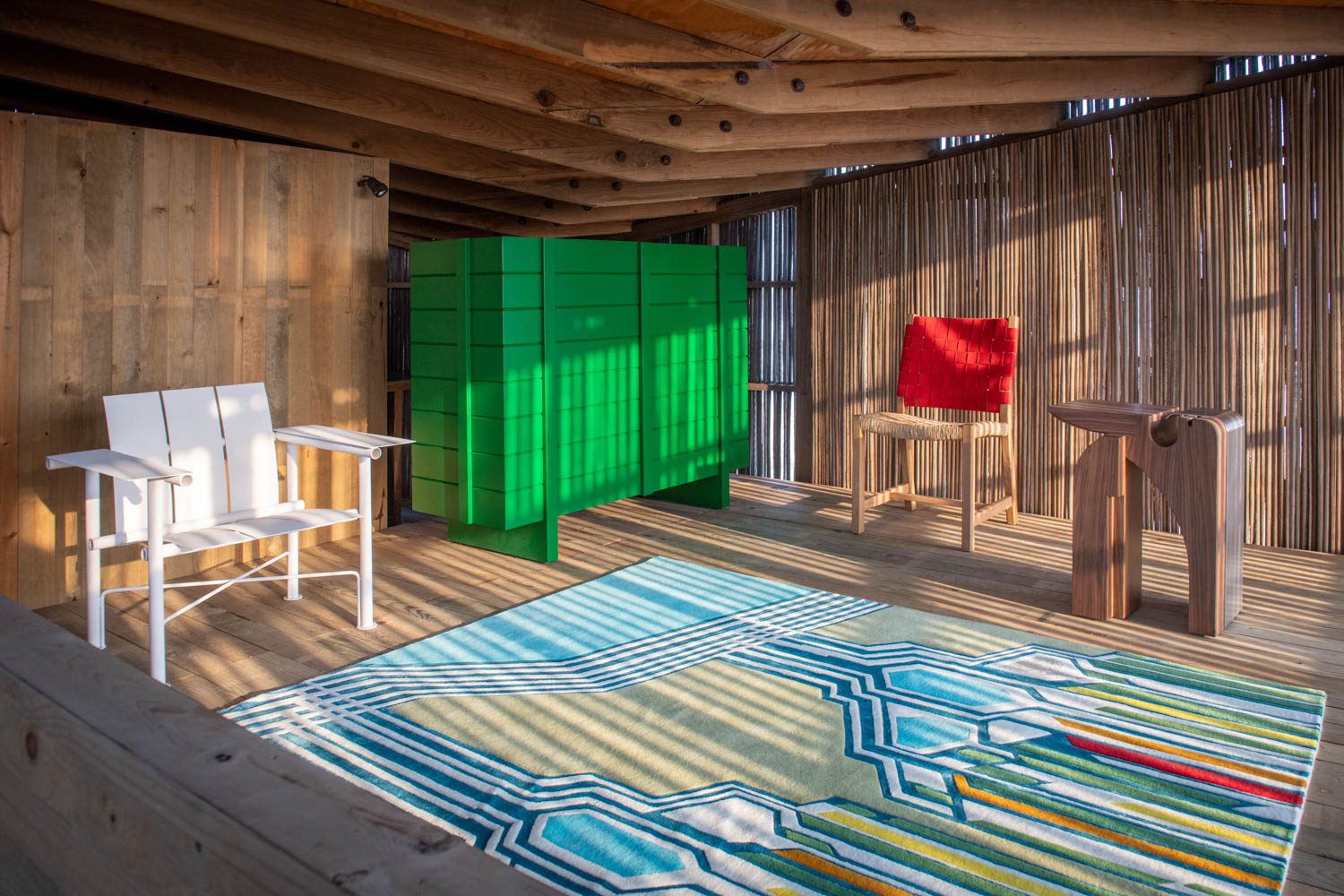 Also inside Casa Naila, its interior wrapped in pine and palm bone, was the white Palma armchair by Marc Morro, the green Redilas I cabinet by Carlos Torre Hütt, the red Arrullo chair by Oscar Hagerman, the Inblock side table by Todomuta Studio, and the Watershed rug by Matali Crasset.