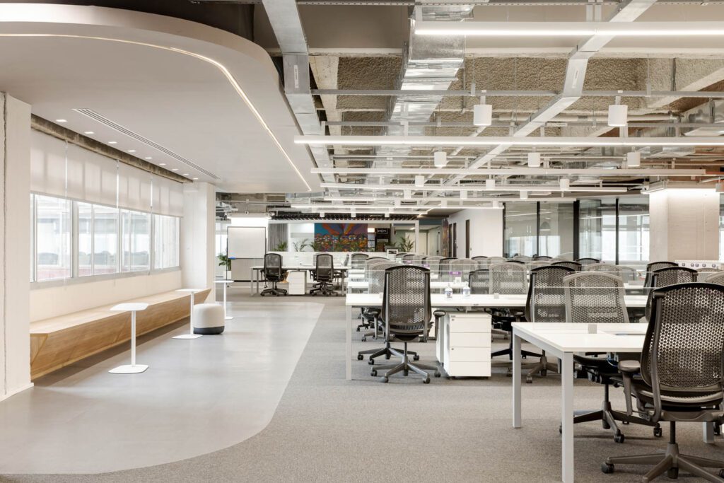 Open work areas are staffed with Fway desking and task chairs beneath lighting by AR Light.