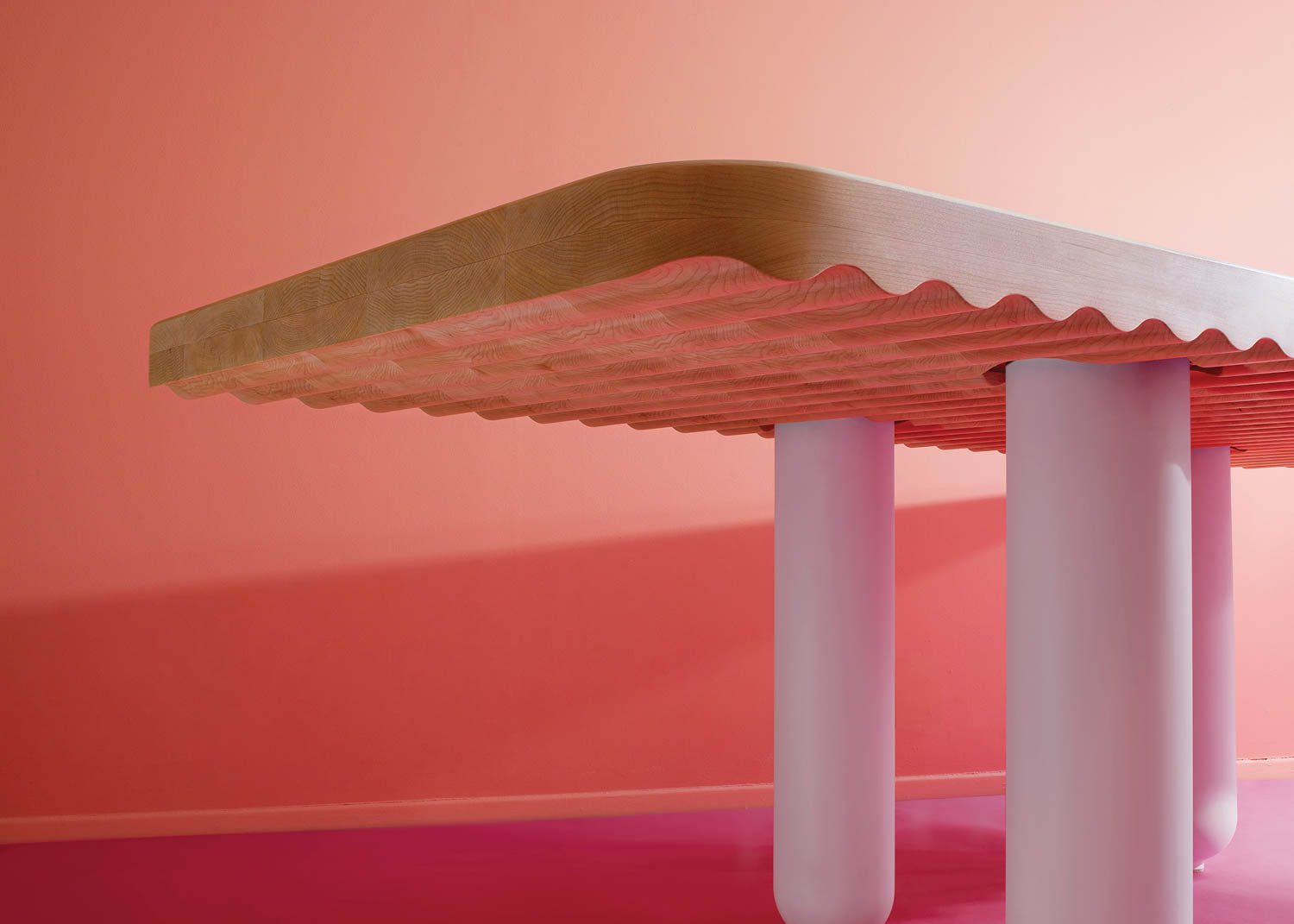 Naminami, a sculptural 96-inch-long dining table via a wavy underside and balloonlike, cylindrical painted legs