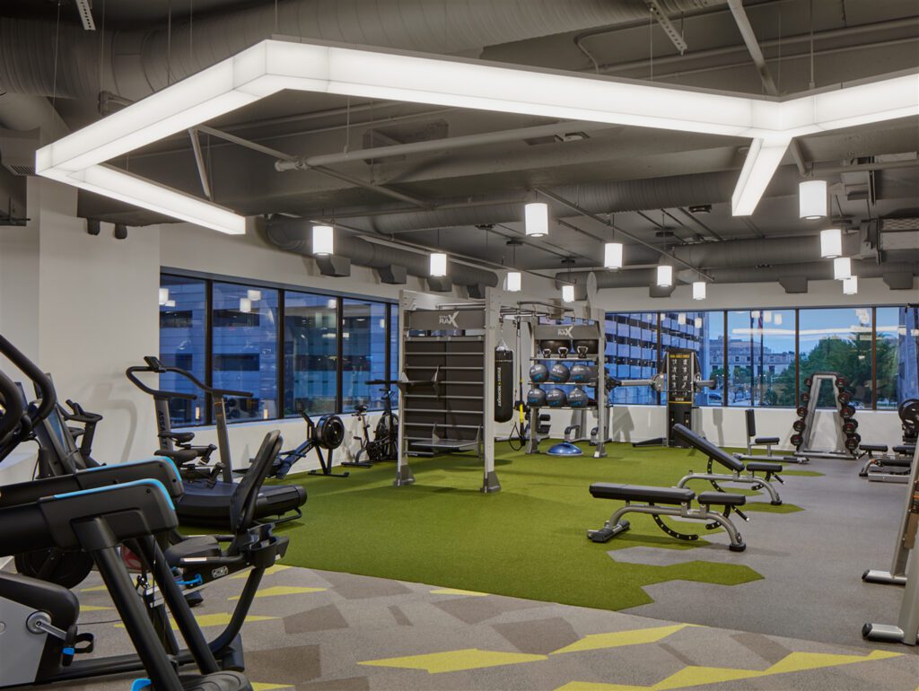 A fitness center offers users views of downtown while Shaw carpet and SPI Lighting elements sandwich the space.