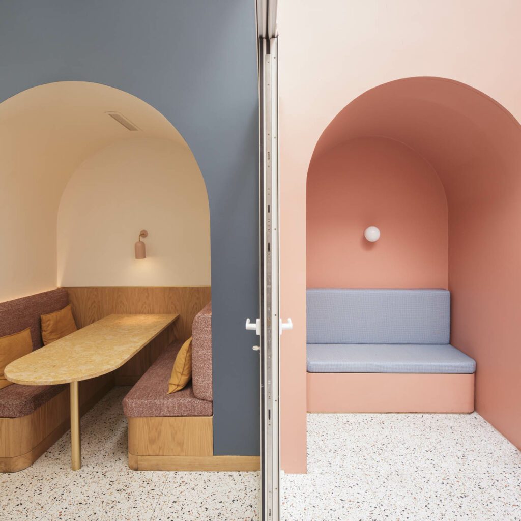 The blue interior patio offers custom tables in Amarelo de Negrais stone with Patrícia Lobo scones, while the pink exterior patio has Zangra sconces and seating with Pedroso & Osório upholstery.
